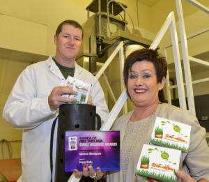 Mark Linton, the AFBI High pressure facility manager congratulates Jacquelyn Stewart of Squeeze Wheatgrass on her quality award.